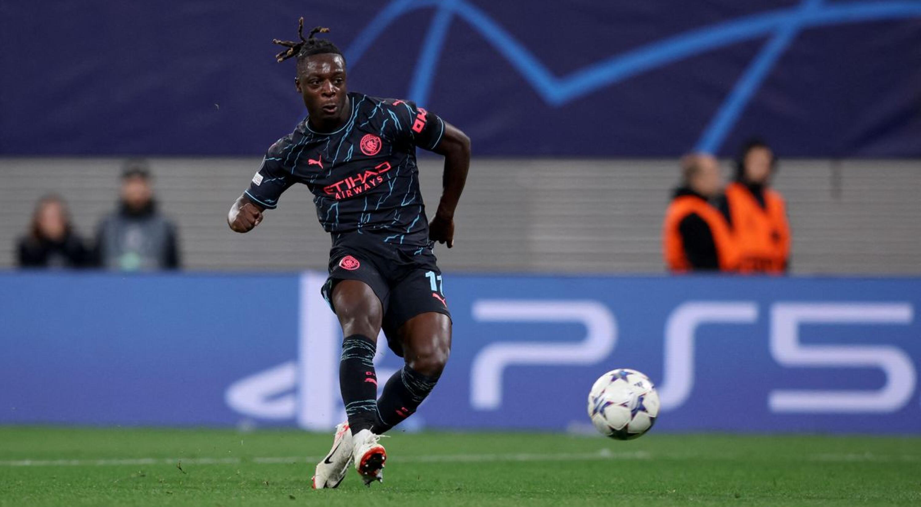 Manchester City's Belgian midfielder #11 Jeremy Doku shoots the ball to score the 1-3 goal during the UEFA Champions League Group G football match between RB Leipzig and Manchester City in Leipzig, eastern Germany