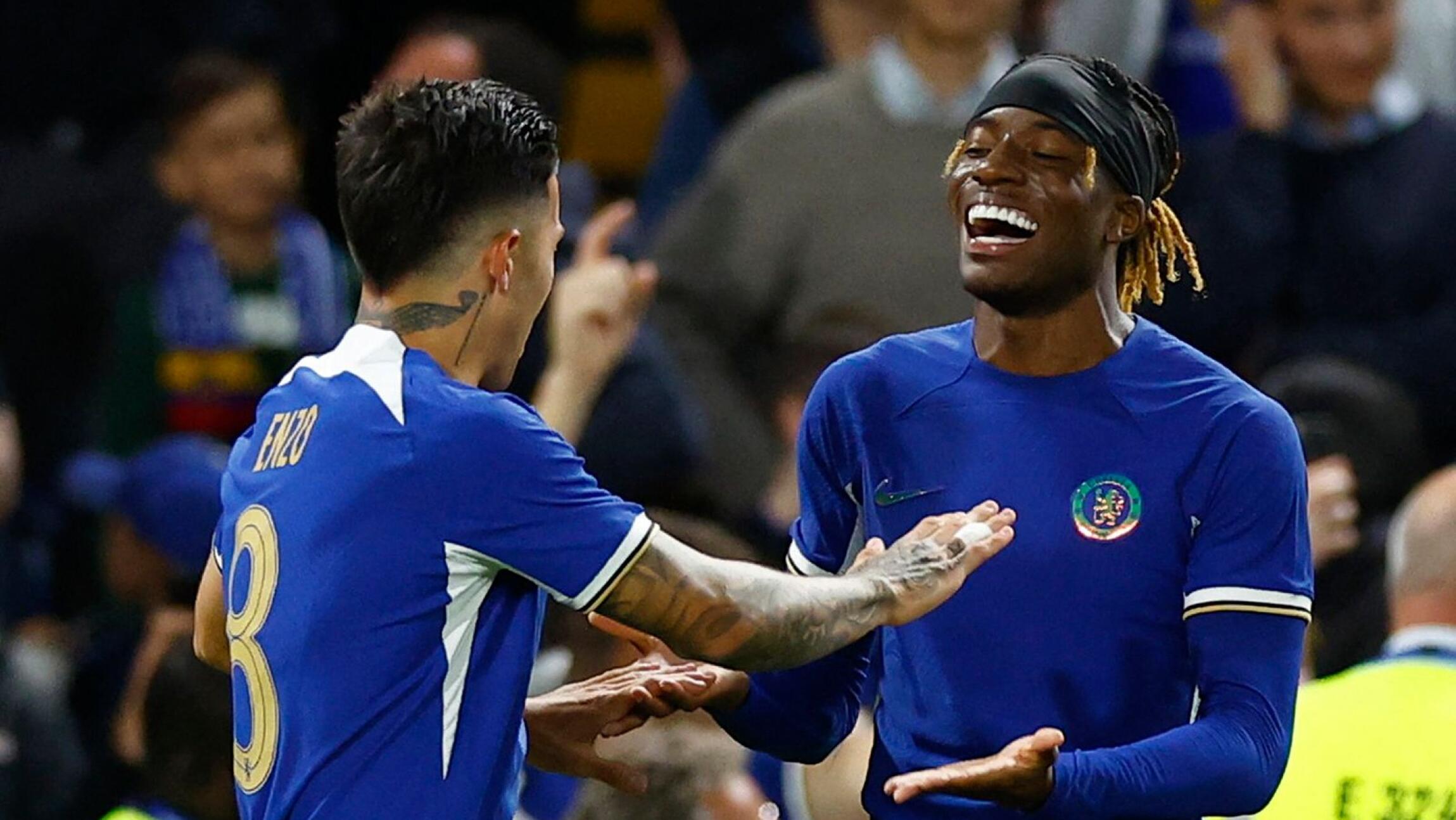 Chelsea's Enzo Fernandez celebrates scoring their second goal against AFC Wimbledon with Noni Madueke