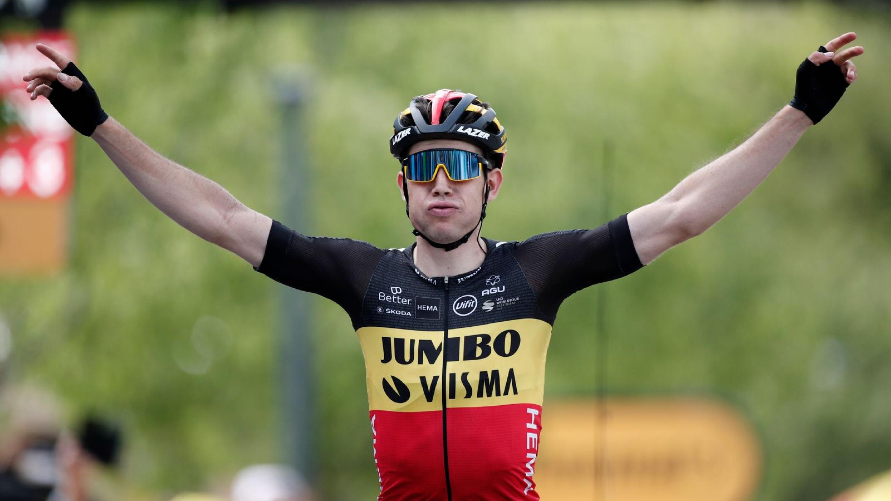 Team Jumbo–Visma rider Wout van Aert of Belgium celebrates as he crosses the finish line to win stage 11 of the Tour de France